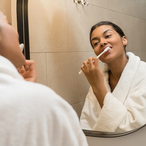 Young woman brushing teeth